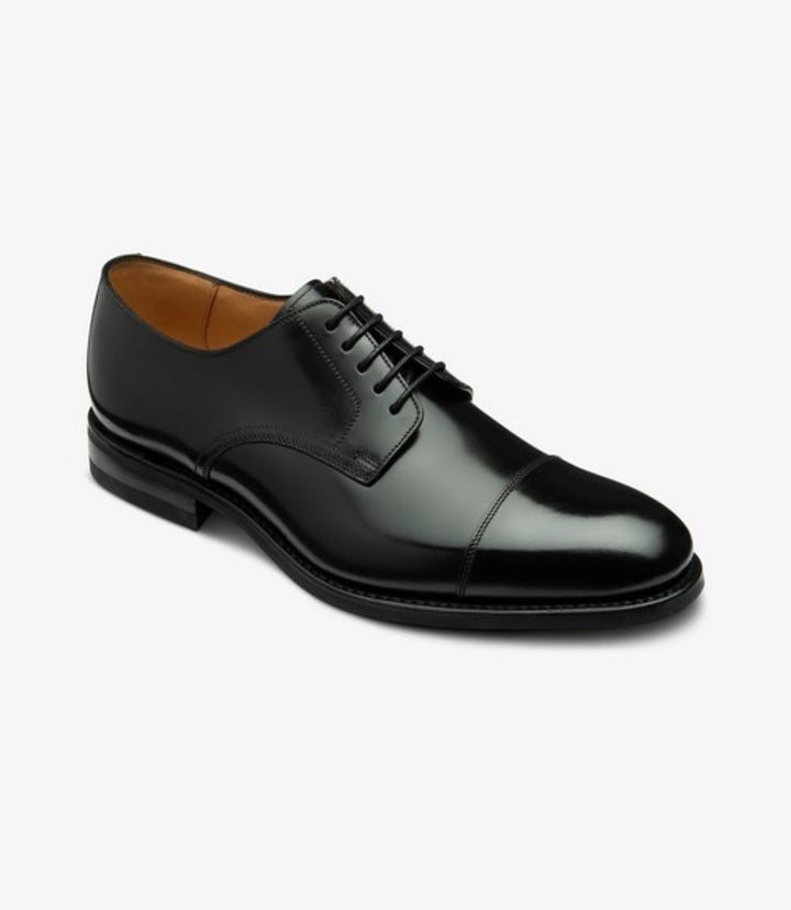 In this angled shot, the shoe's striking design comes to life, revealing the curvature of the upper and the distinct toe-cap feature. The leather's rich texture is accentuated, demonstrating the quality of the material used. The comfortable and sturdy rubber sole adds an element of practicality while maintaining the shoe’s refined aesthetic. This perspective also highlights the fit and structure, ensuring the shoe’s versatility for both formal and smart casual wear.