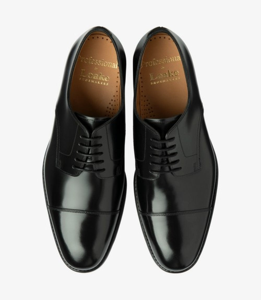 This overhead view presents a symmetrical display of the Loake 305 Black Oxford Toe Cap Shoes. The polished black leather glistens, showcasing the pristine condition and meticulous craftsmanship of both shoes. The toe-cap detailing is clearly visible, providing a classic touch to the overall design. The Goodyear welted rubber soles are evident, reinforcing the shoes' commitment to durability and comfort. This perspective captures the essence of these elegant men's shoes.