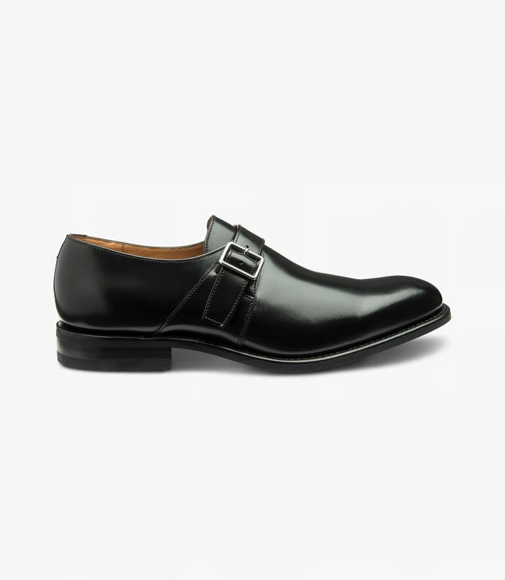 A sleek black oxford shoe with a polished leather finish, showcasing the smooth upper and distinct toe-cap design. The Goodyear welted rubber sole adds a subtle thickness to the bottom, giving the shoe a robust and durable appearance.