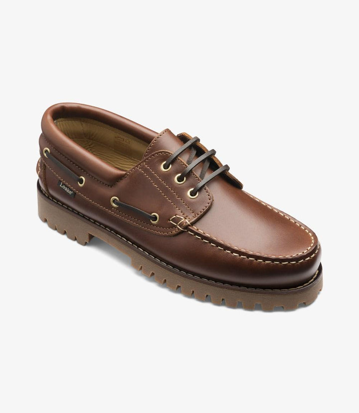 An angled shot of the 522-DIS Brown Boat Shoe, capturing both the side and a hint of the top of the shoe. This view highlights the shoe's design, including the rounded toe and the leather laces. The waxed leather's rich texture and color are accentuated, along with the robust moccasin rubber sole.