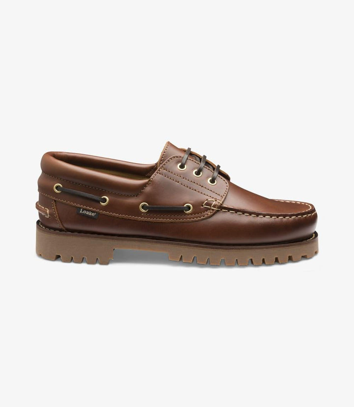 A close-up image of the 522-DIS Brown Boat Shoe from the side, showcasing its sleek profile. The high-quality waxed leather exterior is highlighted, with the moccasin heavy deck rubber sole providing a solid base. The stitching details along the seams are visible, emphasizing the craftsmanship and durability of the shoe.