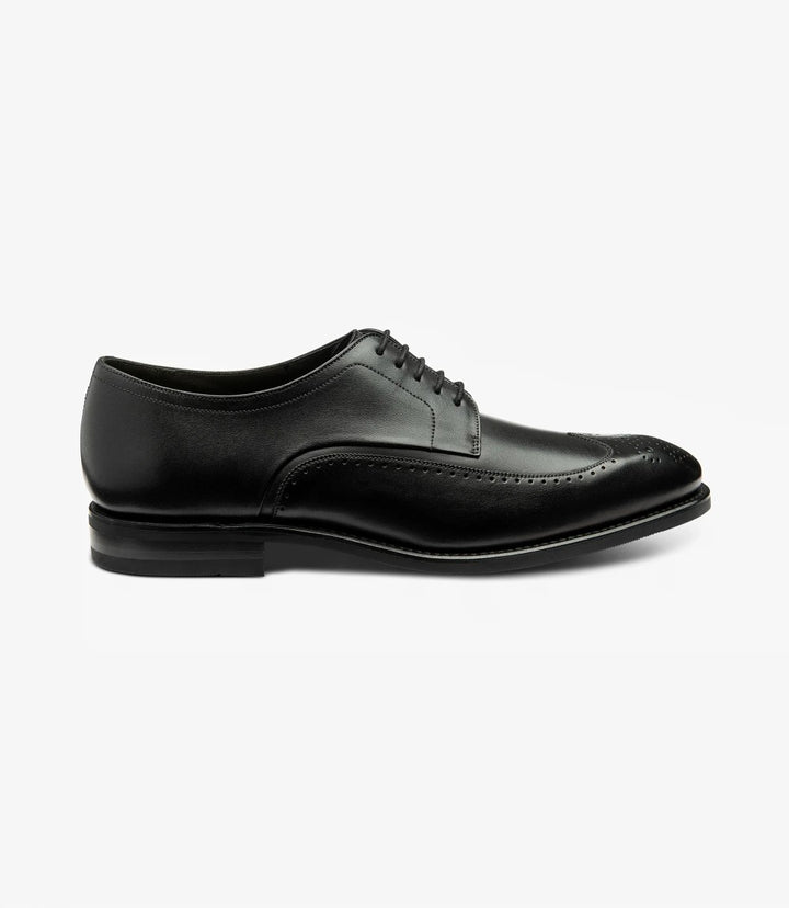 The side view of the Loake Bale Black Derby Brogue showcases its sleek silhouette, highlighting the high-quality calf leather upper with a polished finish. The elegant brogue detailing runs along the edges, adding texture and sophistication. The Goodyear welted shadow rubber sole is clearly visible, emphasizing durability and style.