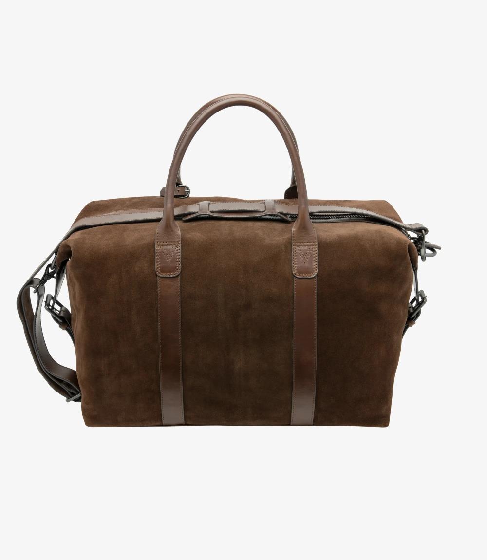 The back view of the Loake Balmoral Polo Suede Weekend Bag offers a clean and streamlined look. The same premium brown polo suede is used throughout, maintaining a cohesive appearance. The detachable shoulder strap is attached at both sides, providing versatility for carrying. The craftsmanship is evident in the stitching details, which add strength and durability. This view emphasizes the bag's refined design, making it a perfect companion for any weekend getaway.