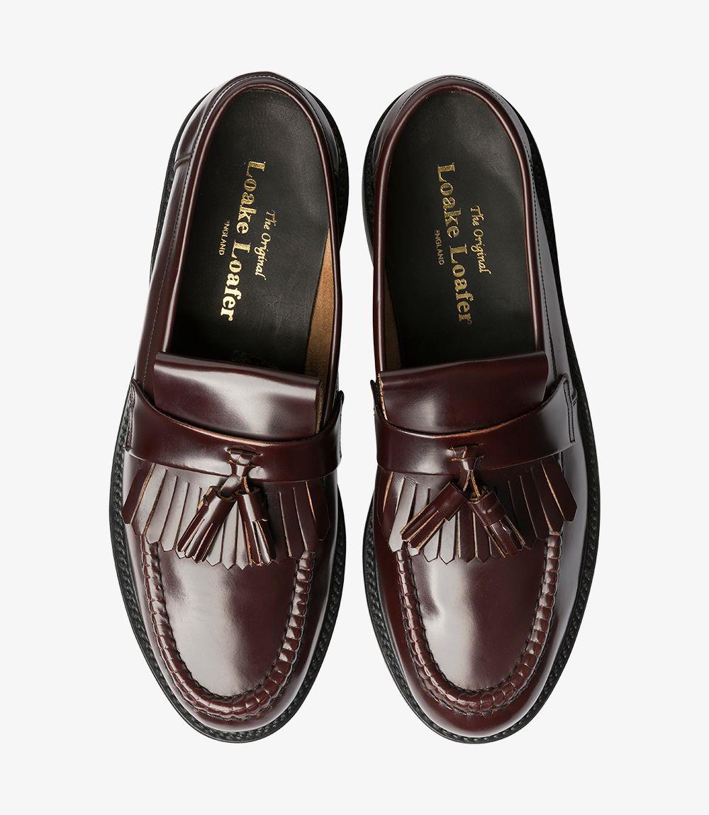 A pair of Brighton-DIS Burgundy Loafers displayed side by side, providing a comprehensive view of both shoes. This image highlights the uniform polish, the iconic tassel design, and the sturdy Goodyear welted leather soles, showcasing the overall craftsmanship.