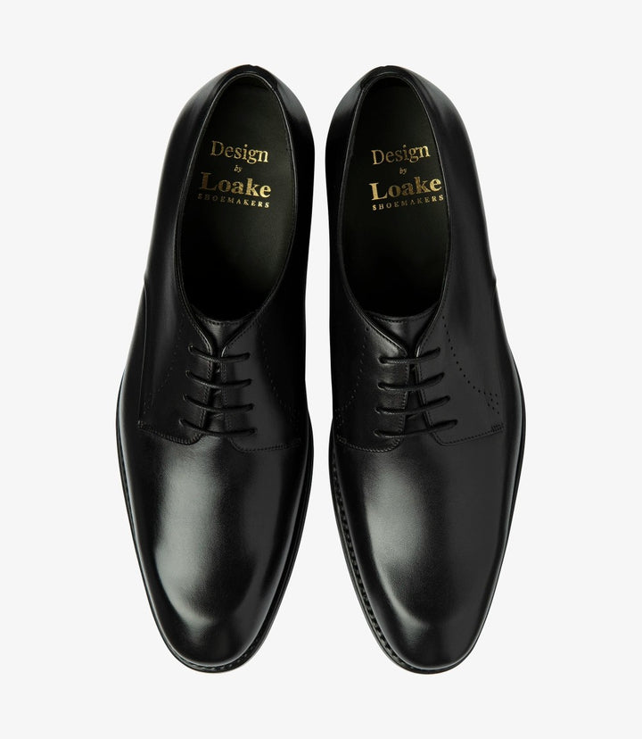 The overhead view of the two shoes displays their symmetrical design and classic shape. The comfortable leather insoles are hinted at, suggesting the shoes’ emphasis on comfort as well as style. This angle also reveals the exquisite craftsmanship, making these derby shoes a timeless addition to any wardrobe.