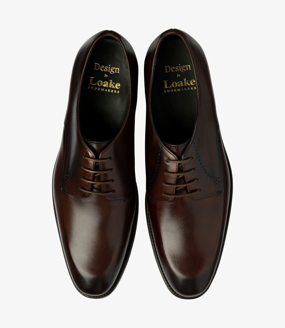 The overhead shot features both Loake Gosling Derby Shoes side by side, illustrating their symmetry and design. The full leather lining and insoles are hinted at through the open tops, while the sleek edges of the shoes create a polished appearance. This perspective highlights their versatility and classic appeal, making them ideal for both formal and casual occasions.