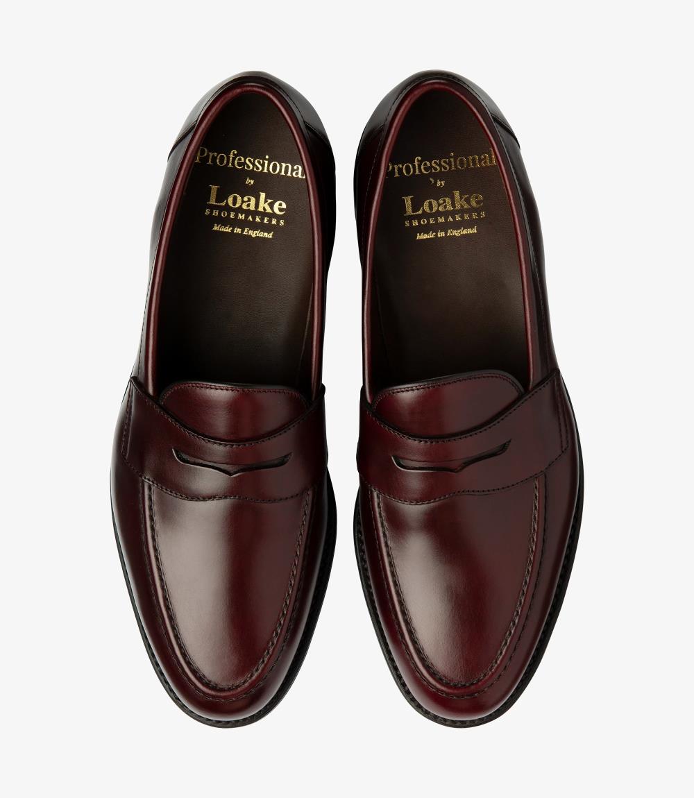 This image captures both loafers from above, offering a comprehensive view of their harmonious design. The smooth, polished leather surfaces reflect a rich depth of color, while the cushioned insoles promise comfort. The classic penny loafer style is evident in the subtle cutout, creating a stylish yet sophisticated look. Together, they embody the perfect blend of elegance and functionality, making them an ideal choice for any gentleman's wardrobe.