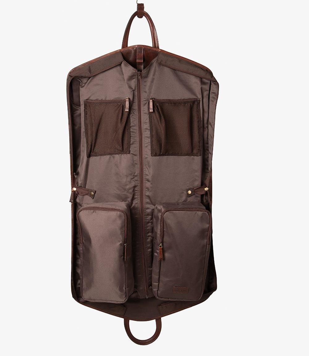 The interior of the suit carrier reveals the well-organized design, with easily accessible shoe pockets built into one side. The pockets are spacious, designed to keep your shoes separated from your suits and accessories. The high-quality lining complements the leather exterior, adding to the overall sophisticated look.