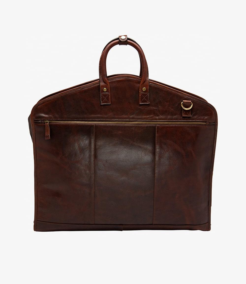 The exterior of the Loake London Dark Brown Leather Suit Carrier showcases its elegant dark brown calf leather, with a smooth and polished finish. The foldable design and sturdy leather handles emphasize both style and practicality. The handy leather hook loop is visible, designed for easy hanging on doors or hooks.