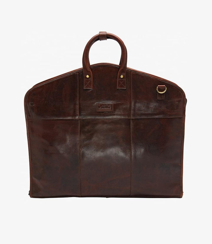 The exterior of the Loake London Dark Brown Leather Suit Carrier showcases its elegant dark brown calf leather, with a smooth and polished finish. The foldable design and sturdy leather handles emphasize both style and practicality. The handy leather hook loop is visible, designed for easy hanging on doors or hooks.