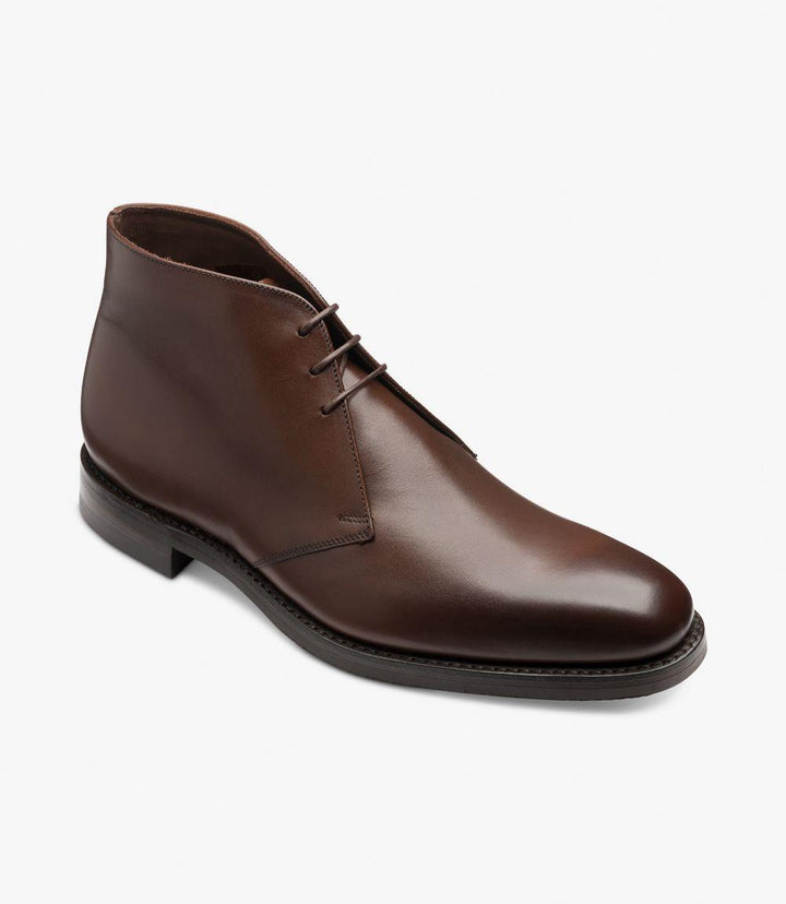 The angled view of the Pimlico-DIS boot highlights the distinctive chukka design and the slight chisel-shaped toe of the Last Capital. The photo captures the elegant burnished leather, the craftsmanship of the Goodyear welted construction, and the robust Danite rubber sole, emphasizing the boot's premium quality and classic style.