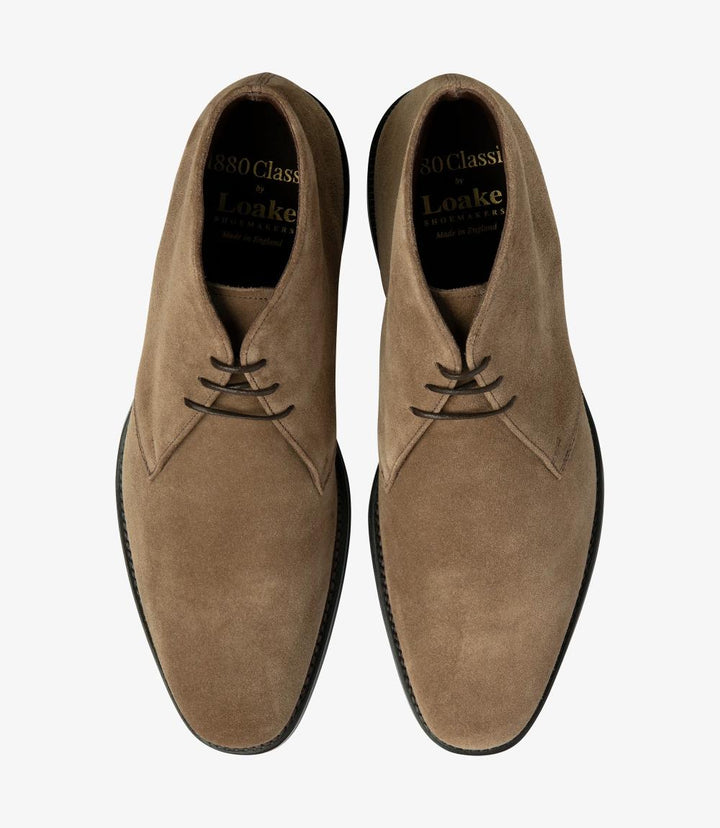 In this overhead perspective, both Loake Pimlico-Suede Flint Boots are displayed side by side, highlighting their uniform elegance. The smooth suede surface and precise stitching are prominently featured, showcasing the attention to detail in their construction. The spacious interior and comfortable leather insoles suggest a cozy fit, making these boots perfect for everyday wear.