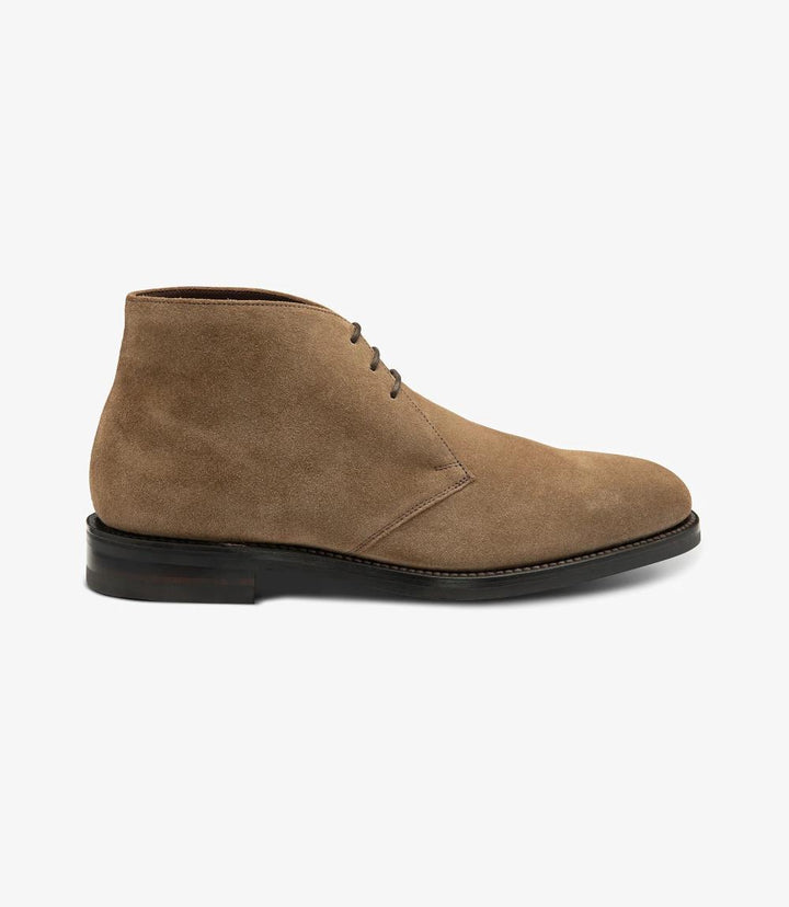 The side profile of the Loake Pimlico-Suede Flint Suede Boot showcases its sleek silhouette and premium suede finish. The smooth contours highlight the elegant derby design, while the Goodyear welt construction is visible, indicating durability. The Danite rubber sole offers a practical yet stylish foundation, ensuring traction and comfort.