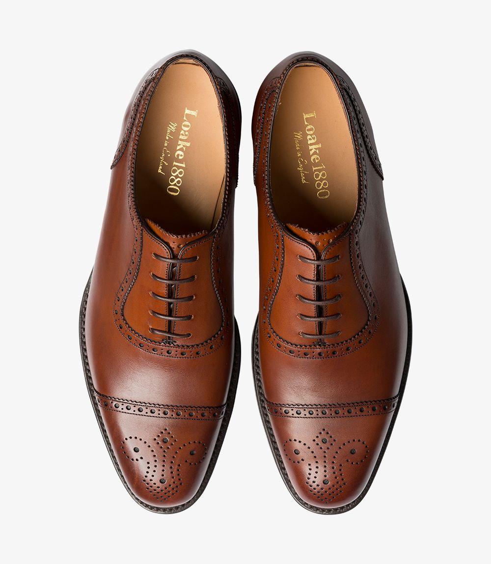 The front view of both shoes in the pair reveals the symmetrical design and uniform mahogany color. The semi brogue detailing on the toe caps is consistent across both shoes, and the leather soles provide a cohesive look. This view highlights the craftsmanship and aesthetic harmony of the pair, perfect for formal occasions.