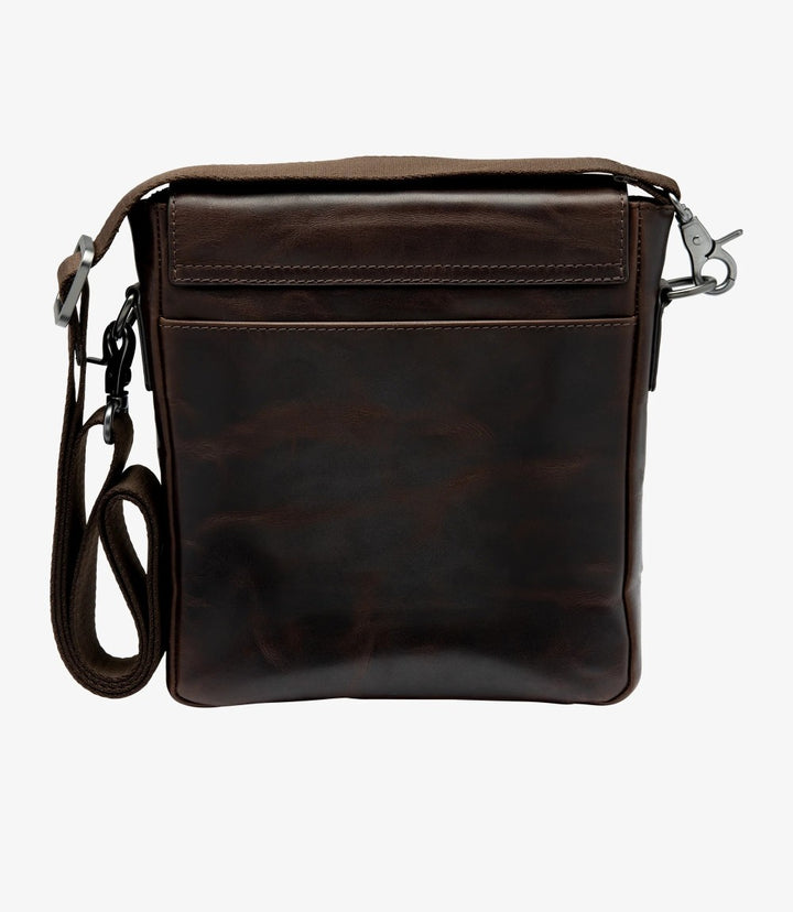 The back view of the Loake Stratford Dark Brown Crossbody Bag displays its sleek and practical design. A rear zip pocket is visible, perfect for quick access to items like your phone or wallet. The adjustable shoulder strap is showcased, demonstrating how it can be easily adjusted for comfort. The smooth, waxy leather on the back has a natural sheen, emphasizing the bag’s high-quality craftsmanship and timeless style.