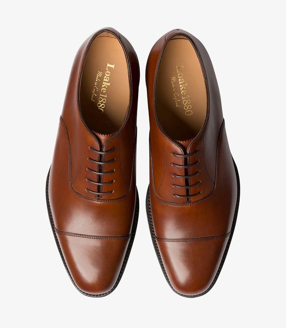 A perspective from above, showing both shoes side by side. The classic Oxford lacing and symmetrical design are apparent, with the rich mahogany leather displaying a uniform polish. The toe cap and stitching lines add elegance to the clean lines and balanced structure.