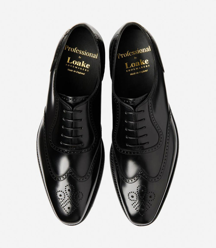 A bird's-eye view of the two Eldon shoes showcases their symmetrical beauty and timeless appeal, with their semi-brogue design and versatile black polished finish, making them the epitome of refined footwear for any occasion.