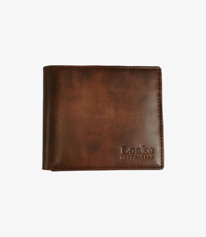 A view of the Loake Export Brown Wallet in its closed form, showcasing its rich, brown calf leather with a smooth, polished finish. The compact, rectangular shape is refined, with subtle stitching along the edges that enhances its sophisticated appearance.