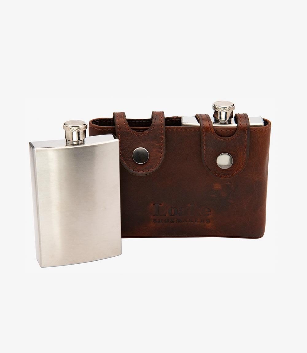 The Loake Tan Flask is elegantly displayed in its refined tan leather pouch, showcasing its sleek and discreet design. The photo highlights the soft texture of the leather and the flask's polished finish. The pouch is shown open, revealing space for two flasks, emphasizing both style and functionality.