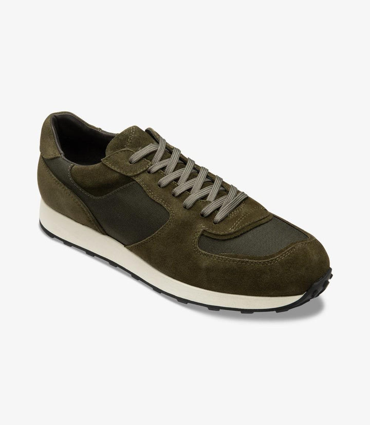 A view of the Loake Foster sneaker from a slight angle, highlighting the suede's natural texture and the structured yet relaxed fit. The angle shows off the cushioned insole and the layered rubber sole, designed for both style and support.