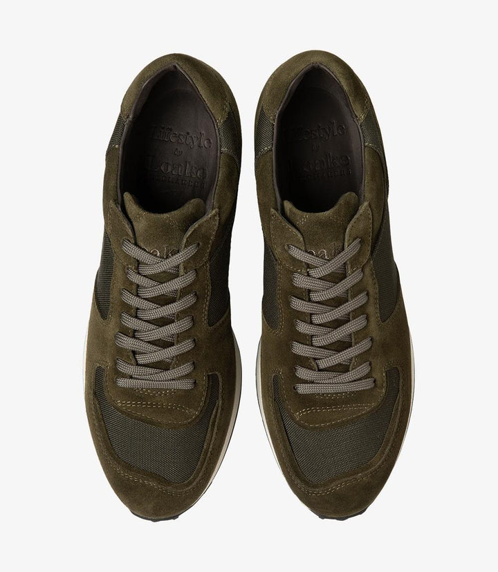 Both Loake Foster sneakers viewed from above, displaying the full, rounded toe shape and the detailed stitch lines across the suede and canvas panels. The laces and tongue are neatly aligned, emphasizing the shoes' sleek, polished finish and casual style.