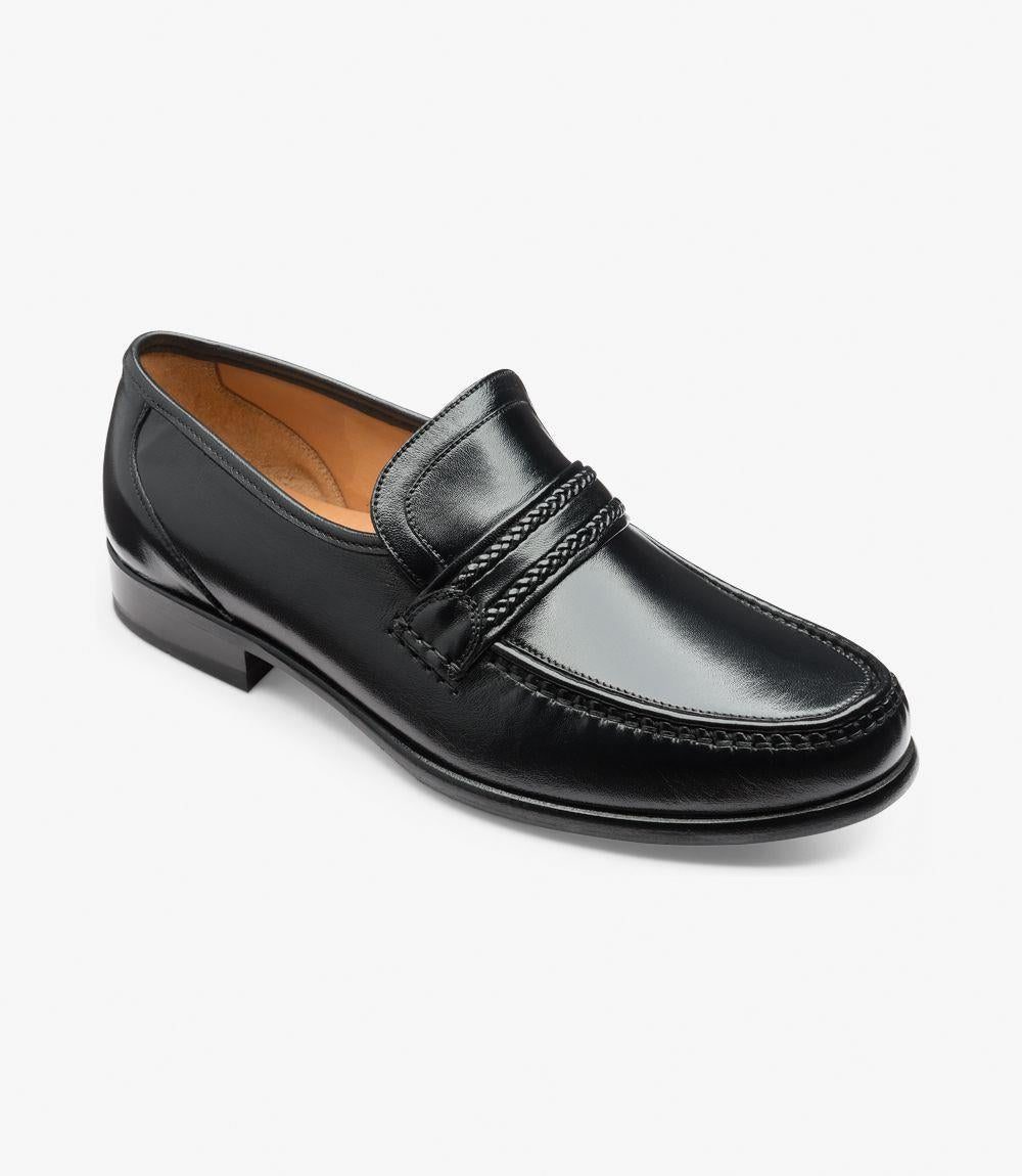 This angled view captures the shoe from the front side, showcasing the rounded toe and the moccasin stitching along the vamp. The slight sheen of the Nappa leather is enhanced from this angle, while the loafer’s shape displays the Rome last’s extra-wide fit.