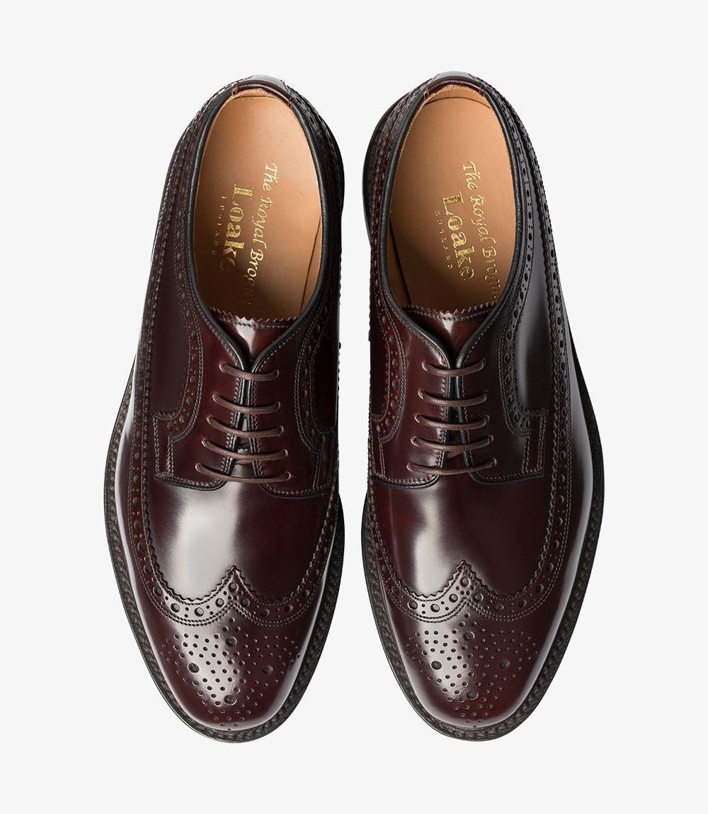 From above, the shoe’s elegant shape is prominent, displaying the wingtip design that arcs along the toe and the carefully punched brogue pattern. The laces are neatly tied over the vamp, and the top view captures the balance of classic style with modern appeal.